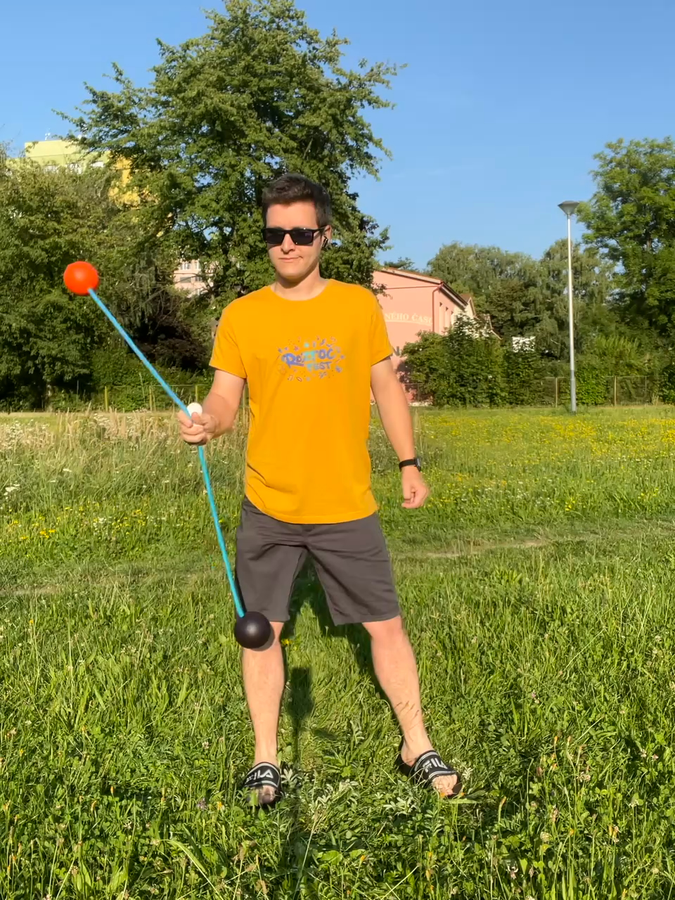 Matěj practicing with poi in a field